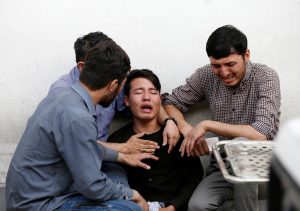 Afghan men mourn after a blast in a hospital in Kabul, Afghanistan August 15, 2018. REUTERS/Mohammad Ismail