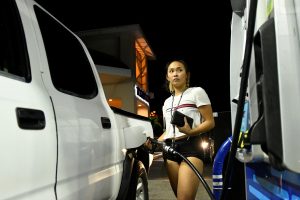 Jaycee Sotello fills her truck up with gas as Hurricane Lane approaches Honolulu, Hawaii, U.S. August 21, 2018. REUTERS/Hugh Gentry