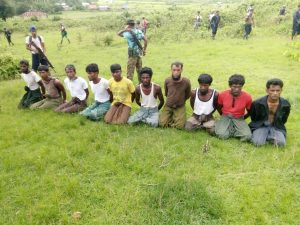 FILE PHOTO: Ten Rohingya Muslim men with their hands bound kneel as members of the Myanmar security forces stand guard in Inn Din village September 2, 2017. REUTERS/File Photo