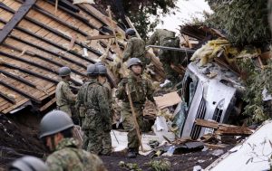 Members of the Japan Self-Defense Forces (JSDF) search for survivors from a house damaged by a landslide caused by an earthquake in Atsuma town, Hokkaido, northern Japan, in this photo taken by Kyodo September 7, 2018. Kyodo/via REUTERS