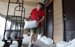 John Muchmore helps to lay sandbags at the Afterdeck condos ahead of the arrival of Hurricane Florence in Garden City Beach, South Carolina, U.S., September 11, 2018. REUTERS/Randall Hill