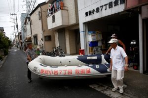 FILE PHOTO: Residents of Tokyo's Katsushika ward show a floating boat which they keep for a possible flood in Tokyo, Japan August 24, 2018. REUTERS/Kim Kyung-Hoon
