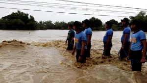 People prepare to rescue a man (not pictured) trapped in raging flood waters caused by Typhoon Mangkhut in Tarlac, Philippines, in this still image from a September 15, 2018 video from social media. Aquino Lord/Social Media/via REUTERS