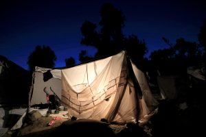 A tent is illuminated at a makeshift camp next to the Moria camp for refugees and migrants on the island of Lesbos, Greece, September 18, 2018. REUTERS/Giorgos Moutafis