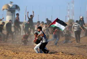 A wounded Palestinian is evacuated during a protest calling for lifting the Israeli blockade on Gaza and demanding the right to return to their homeland, at the Israel-Gaza border fence, in the southern Gaza Strip September 21, 2018. REUTERS/Ibraheem Abu Mustafa
