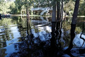 FILE PHOTO: Water from the flooded Waccamaw River surrounds a house in the aftermath of Hurricane Florence now downgraded to a tropical depression in Conway, South Carolina, U.S. September 19, 2018. REUTERS/Randall