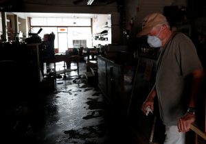 Randy Britt take a break as he works to clean one of his downtown buildings after flooding due to Hurricane Florence receded in Fair Bluff, North Carolina, U.S. September 29, 2018. REUTERS/Randall Hill