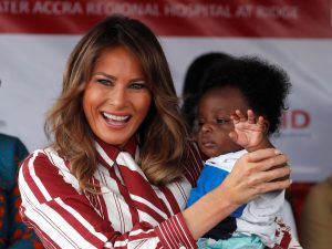 U.S. first lady Melania Trump holds a child during a visit to a hospital in Accra, Ghana. REUTERS/Carlo Allegri