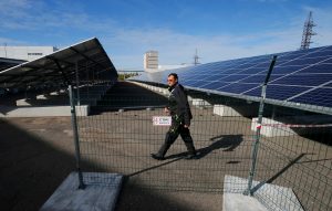 An employee walks past solar panels at a solar power plant built on the site of the world's worst nuclear disaster, Chernobyl, Ukraine October 5, 2015. REUTERS/Gleb Garanich