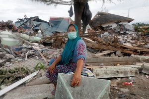 A woman sits in front of her home in the earthquake and liquefaction affected Balaroa neighbourhood in Palu, Central Sulawesi, Indonesia, October, 11 2018. REUTERS/Darren Whiteside