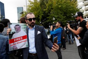 A man holds a picture of Saudi journalist Jamal Khashoggi as media members film during a protest outside the Saudi Consulate in Istanbul, Turkey October 8, 2018. REUTERS/Murad Sezer