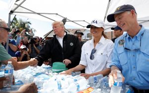 U.S. President Donald Trump, first lady Melania Trump and Florida Governor Rick Scott (R) help distribute water in the town of Lynn Haven, Florida, during a tour of areas ravaged by Hurricane Michael in Florida U.S., October 15, 2018. REUTERS/Kevin Lamarque