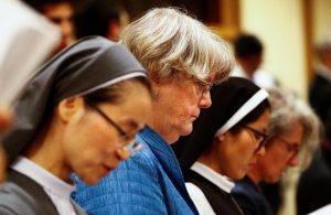 FILE PHOTO: Sister Sally Hodgdon (2nd L) stands during a synod afternoon session led by Pope Francis at the Vatican October 16, 2018. Picture taken October 16, 2018. REUTERS/Max Rossi