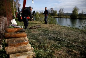 A deminer from a bomb-disposal unit moves an unexploded shell recovered in the Meuse River at Sivry-sur-Meuse, close to WWI battlefields, near Verdun, France, October 23, 2018 before the centenial commemoration of the First World War Armistice Day. REUTERS/Pascal Rossignol