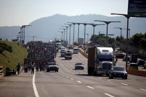 People walk in a caravan of migrants departing from El Salvador en route to the United States, in San Salvador, El Salvador, October 31, 2018. REUTERS/Jose Cabezas
