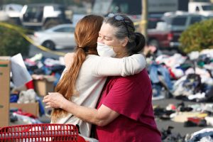 Maddy Mudd, 25, of Oakhurst, hugs Camp Fire evacuee Terri Wolfe, 62, of Paradise, at a donation site for evacuees in Chico, California, U.S., November 18, 2018. REUTERS/Terray Sylvester