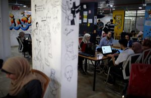 Members of 'We Are Not Numbers' team work on laptops in an office in Gaza City November 7, 2018. Picture taken November 7, 2018. REUTERS/Mohammed Salem