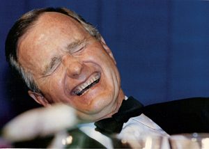 FILE PHOTO: U.S. President George H.W. Bush laughs while attending the annual White House Correspondents Association Awards dinner in Washington May 21, 1988. REUTERS/Stelios Varias/File Photo