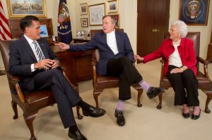 FILE PHOTO: Republican presidential candidate Mitt Romney (L) picks up the formal endorsement of former President George H.W. Bush and former first lady Barbara Bush in Houston March 29, 2012. REUTERS/Donna Carson/File Photo
