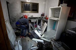 A man inspects the damage in a house where a Palestinian gunman was killed by Israeli forces, near Nablus in the Israeli-occupied West Bank December 13, 2018. REUTERS/Abed Omar Qusini