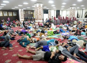 Residents, who lived at coast of Bandar Lampung, rest at government building after they evacuated following a tsunami hit Sunda strait in Lampung, Indonesia, in this December 24, 2018 photo taken by Antara Foto. Antara Foto/Ardiansyah/ via REUTERS