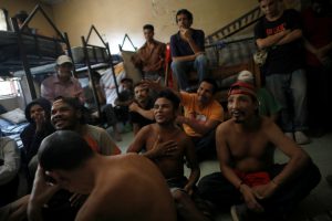 Civilians and former gang members gesture inside a rehabilitation centre in Tegucigalpa, Honduras, July 13, 2018. REUTERS/Edgard Garrido