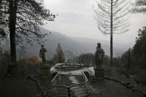 FILE PHOTO: Statues are seen on a property damaged by the Camp Fire in Paradise, California, U.S. November 21, 2018. REUTERS/Elijah Nouvelage/File Photo