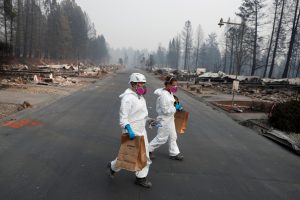FILE PHOTO: Forensic anthropologists recover remains from a trailer home destroyed by the Camp Fire in Paradise, California, U.S., November 17, 2018. REUTERS/Terray Sylvester/File Photo